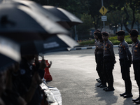 Police stand guard during the 835th Aksi Kamisan, or Thursday's Protest, in front of the Presidential Palace in Jakarta, Indonesia, on Octob...