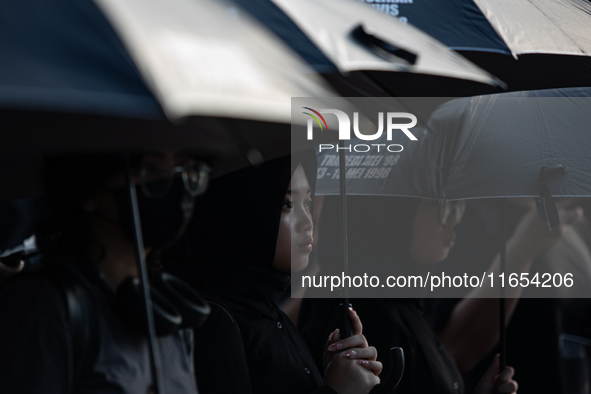 Human rights activists participate in the 835th Aksi Kamisan, or Thursday's Protest, in front of the Presidential Palace in Jakarta, Indones...