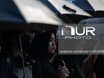 Human rights activists participate in the 835th Aksi Kamisan, or Thursday's Protest, in front of the Presidential Palace in Jakarta, Indones...