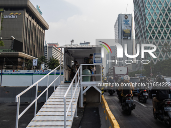 People are at a bus stop in the business district of Jakarta, Indonesia, on October 10, 2024. According to the Expert Council of the Nationa...