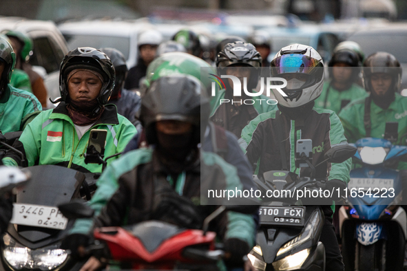 Motorcycle taxis are caught in traffic congestion in the business district of Jakarta, Indonesia, on October 10, 2024. According to the Expe...