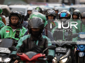 Motorcycle taxis are caught in traffic congestion in the business district of Jakarta, Indonesia, on October 10, 2024. According to the Expe...