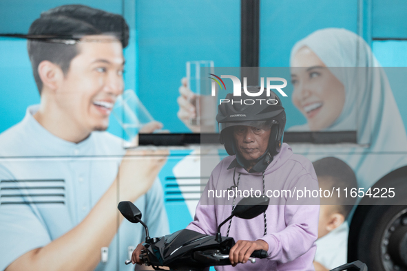 Motorcyclists pass through the business district of Jakarta, Indonesia, on October 10, 2024. According to the Expert Council of the National...