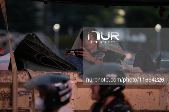 A passenger in a truck passes through the business district of Jakarta, Indonesia, on October 10, 2024. According to the Expert Council of t...