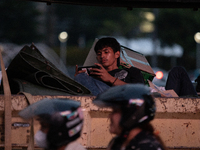 A passenger in a truck passes through the business district of Jakarta, Indonesia, on October 10, 2024. According to the Expert Council of t...