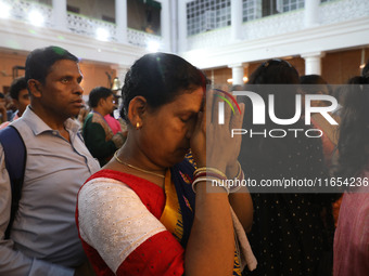 A woman offers prayer at a heritage house during the Durga Puja festival in Kolkata, India, on October 10, 2024. The annual Durga Puja festi...