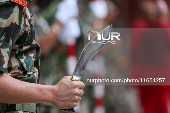 A Nepal Army personnel stands guard ahead of the formal beginning of the Phulpati procession in Kathmandu, Nepal, on October 10, 2024. 