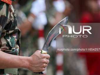 A Nepal Army personnel stands guard ahead of the formal beginning of the Phulpati procession in Kathmandu, Nepal, on October 10, 2024. (