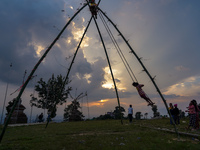 People play on a traditional bamboo swing during the Dashain festival in the outskirts of Kathmandu, Nepal, on October 10, 2024. (