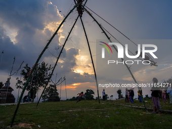 People play on a traditional bamboo swing during the Dashain festival in the outskirts of Kathmandu, Nepal, on October 10, 2024. (