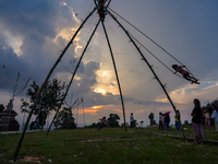 People play on a traditional bamboo swing during the Dashain festival in the outskirts of Kathmandu, Nepal, on October 10, 2024. (