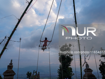 People play on a traditional bamboo swing during the Dashain festival in the outskirts of Kathmandu, Nepal, on October 10, 2024. (