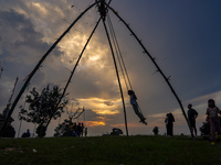 People play on a traditional bamboo swing during the Dashain festival in the outskirts of Kathmandu, Nepal, on October 10, 2024. (