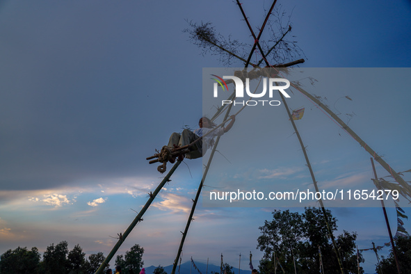 People play on a traditional bamboo swing during the Dashain festival in the outskirts of Kathmandu, Nepal, on October 10, 2024. 