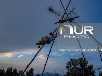 People play on a traditional bamboo swing during the Dashain festival in the outskirts of Kathmandu, Nepal, on October 10, 2024. (