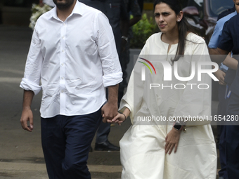 Indian businessman and chairman of Reliance Jio, Akash Ambani, with his wife Shloka Mehta, arrives to pay tribute to the mortal remains of I...