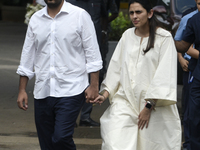 Indian businessman and chairman of Reliance Jio, Akash Ambani, with his wife Shloka Mehta, arrives to pay tribute to the mortal remains of I...