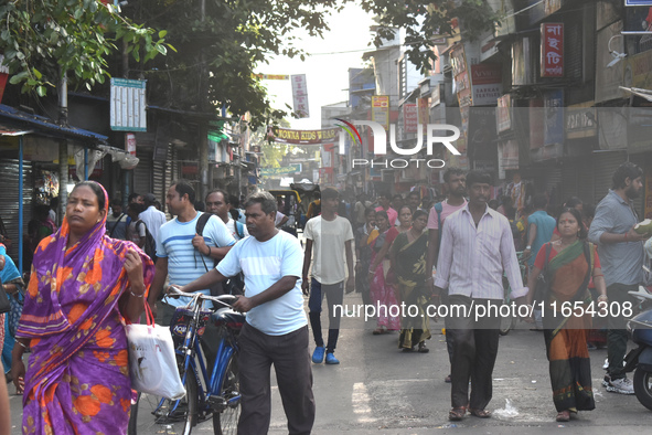 People walk inside a market in Kolkata, India, on October 10, 2024. 