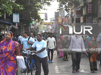 People walk inside a market in Kolkata, India, on October 10, 2024. (