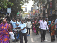 People walk inside a market in Kolkata, India, on October 10, 2024. (