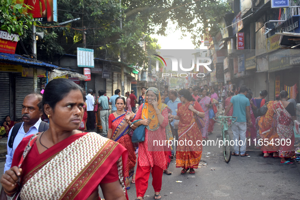 People walk inside a market in Kolkata, India, on October 10, 2024. 