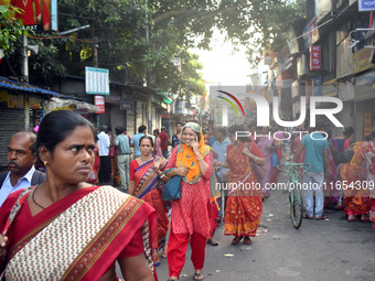 People walk inside a market in Kolkata, India, on October 10, 2024. (