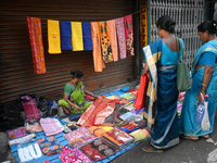 A woman sells garments inside a market in Kolkata, India, on October 10, 2024. (