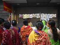 Women buy imitation jewelry on the occasion of the Durga Puja festival from a roadside shop inside a market in Kolkata, India, on October 10...