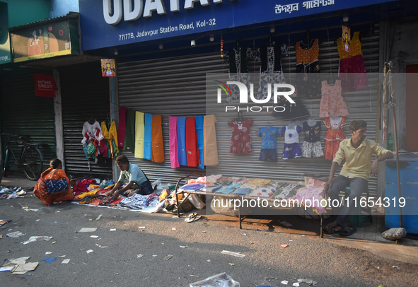 People sell garments inside a market in Kolkata, India, on October 10, 2024. 