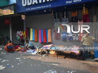 People sell garments inside a market in Kolkata, India, on October 10, 2024. (