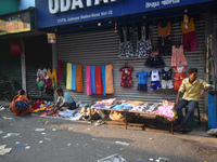 People sell garments inside a market in Kolkata, India, on October 10, 2024. (