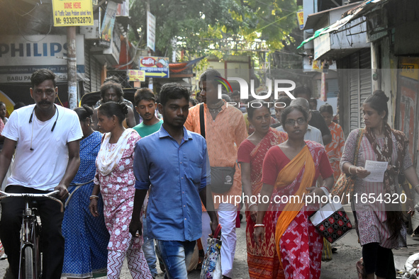 People walk inside a market in Kolkata, India, on October 10, 2024. 