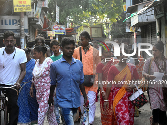 People walk inside a market in Kolkata, India, on October 10, 2024. (