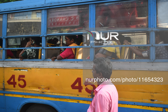 People travel on a private bus in Kolkata, India, on October 10, 2024. 