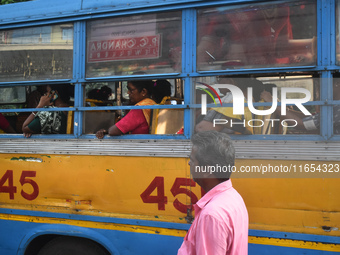 People travel on a private bus in Kolkata, India, on October 10, 2024. (