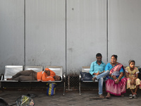 A food delivery person sleeps inside a bus stand in Kolkata, India, on October 10, 2024. (