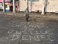 A person cleans a bus stand in the early morning in Kolkata, India, on October 10, 2024. (