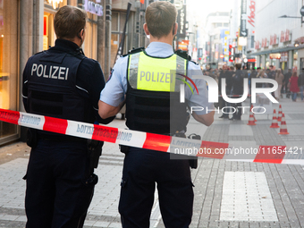 Police block the site at a shopping area after a knife attack in the city center of Cologne, Germany, on October 10, 2024. (