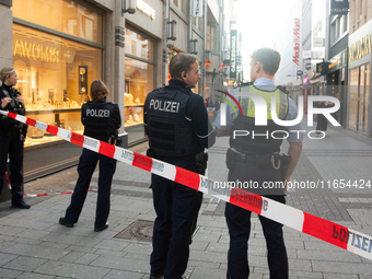 Police block the site at a shopping area after a knife attack in the city center of Cologne, Germany, on October 10, 2024. (