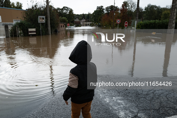 A kid watches the flood in Pommeuse, Seine-et-Marne department, east of Paris, on October 10, 2024, as the heavy rains associated with the K...