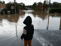 A kid watches the flood in Pommeuse, Seine-et-Marne department, east of Paris, on October 10, 2024, as the heavy rains associated with the K...