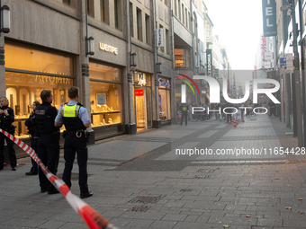 Police block the site at a shopping area after a knife attack in the city center of Cologne, Germany, on October 10, 2024. (