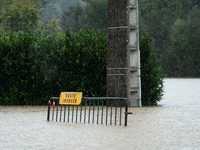 A road sign reads ''flooded road'' on a flooded street in Pommeuse, Seine-et-Marne department, east of Paris, on October 10, 2024, as the he...