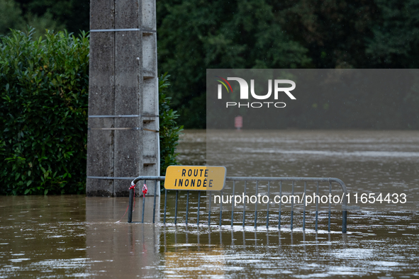 A road sign reads ''flooded road'' on a flooded street in Pommeuse, Seine-et-Marne department, east of Paris, on October 10, 2024, as the he...