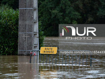 A road sign reads ''flooded road'' on a flooded street in Pommeuse, Seine-et-Marne department, east of Paris, on October 10, 2024, as the he...