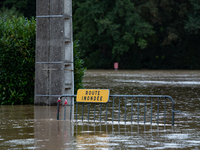 A road sign reads ''flooded road'' on a flooded street in Pommeuse, Seine-et-Marne department, east of Paris, on October 10, 2024, as the he...