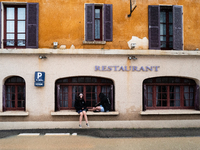 Two young people sit next to a flooded street in Coulommiers, Seine-et-Marne department, east of Paris, on October 10, 2024, as the heavy ra...