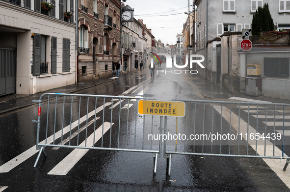 A road sign that reads ''flooded road'' is displayed on a flooded street in Coulommiers, Seine-et-Marne department, east of Paris, on Octobe...