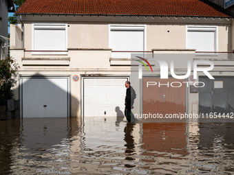 A man walks down a flooded street in Coulommiers, Seine-et-Marne department, east of Paris, on October 10, 2024, as the heavy rains associat...