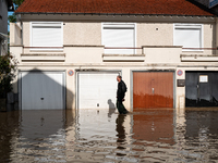 A man walks down a flooded street in Coulommiers, Seine-et-Marne department, east of Paris, on October 10, 2024, as the heavy rains associat...